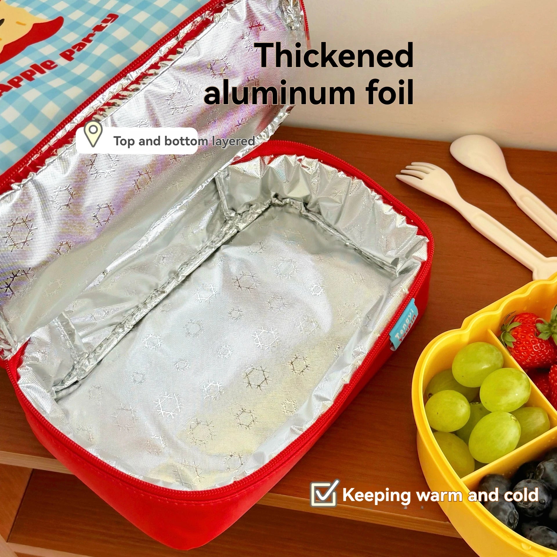 Thickened aluminum foil in a kawaii lunch box with food items on a wooden surface