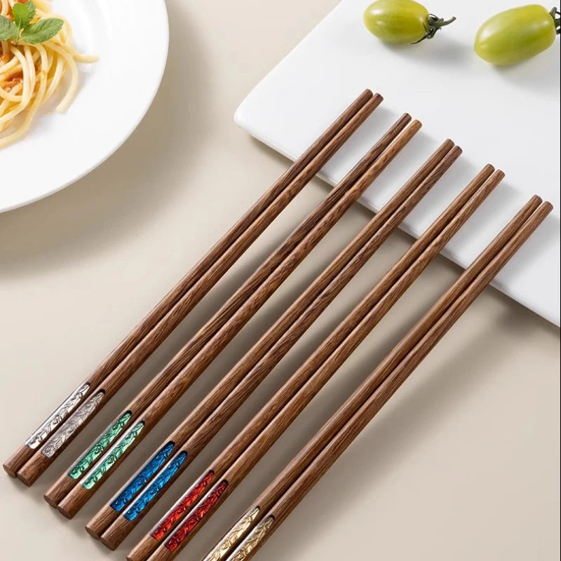 Set of wooden kawaii chopsticks with colorful ends on a neutral background