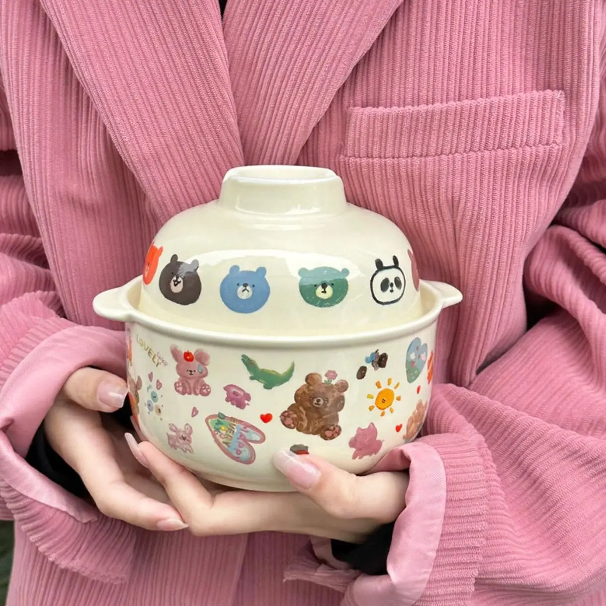 A white kawaii bowl with a lid and cartoons on it
