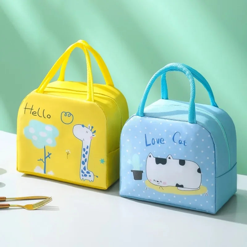 Yellow and blue kawaii lunch bags with cartoon designs on a light green background