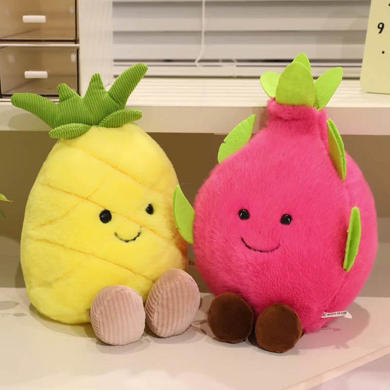 Two kawaii plush toys shaped like a pineapple and a dragon fruit on a surface.