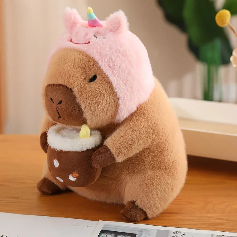 Kawaii plush toy resembling a bear in a unicorn hat on a wooden surface