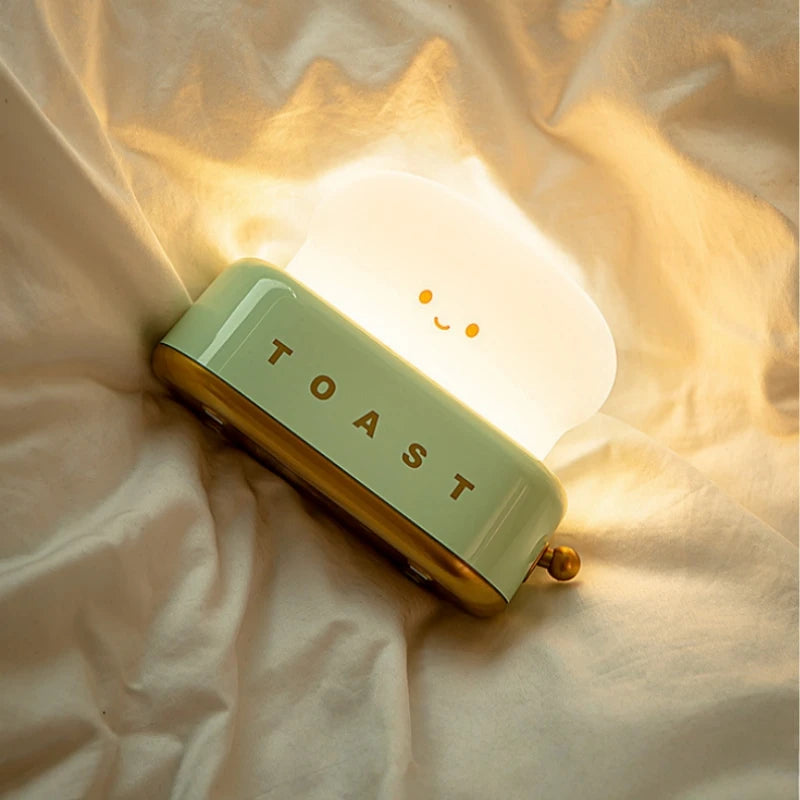 Kawaii toy toaster with a smiling face on a soft fabric background