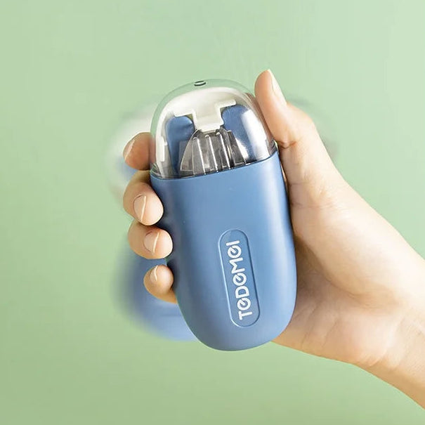 Hand holding a blue kawaii utensils case with 'tedamoi' branding against a light green background