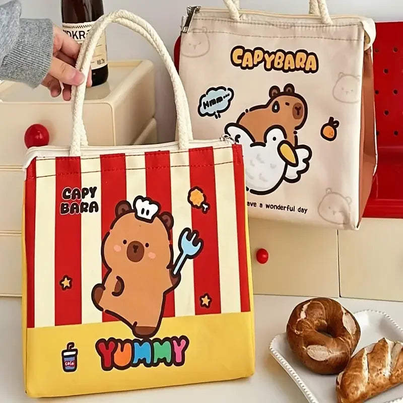 Two kawaii cartoon-themed tote bags with capybara designs on a table with pastries.