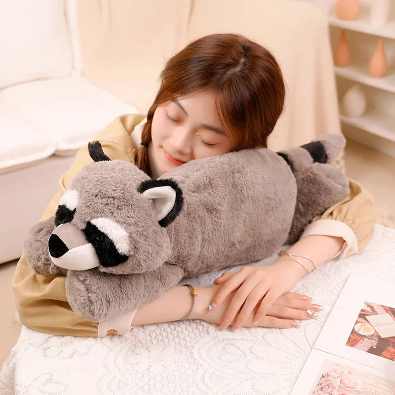 Person holding a raccoon-shaped kawaii plush toy on a couch
