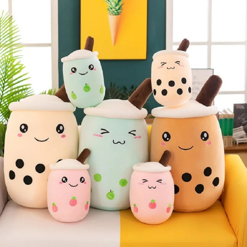 Set of kawaii plush toys shaped like bubble tea cups on a yellow couch.