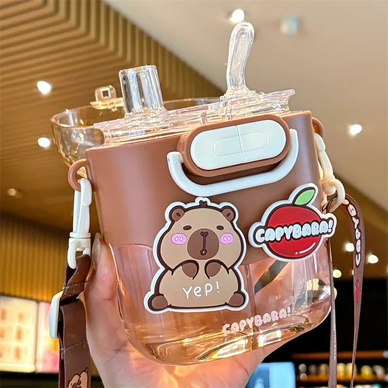 Kawaii themed water bottle with brown cap and bear character design held in a hand.