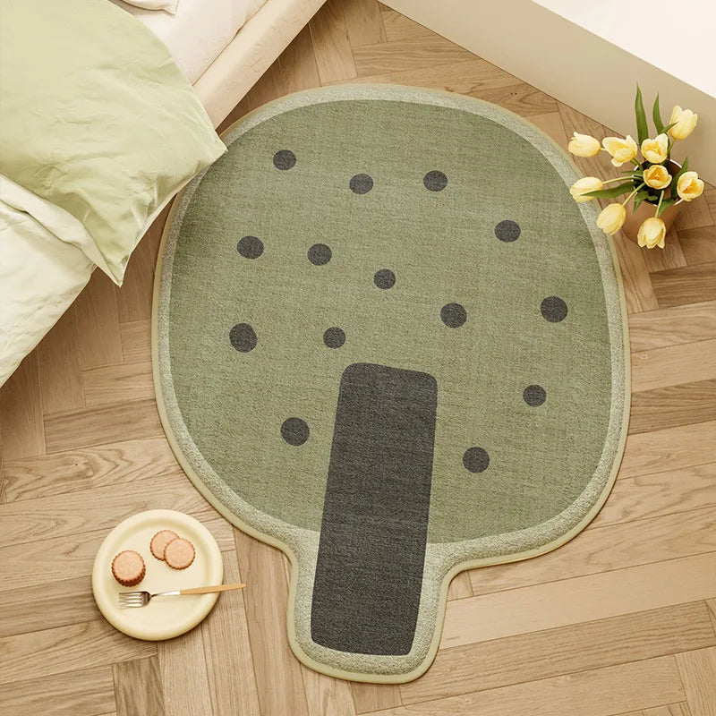 Green kawaii bath mat with black dots on a wooden floor