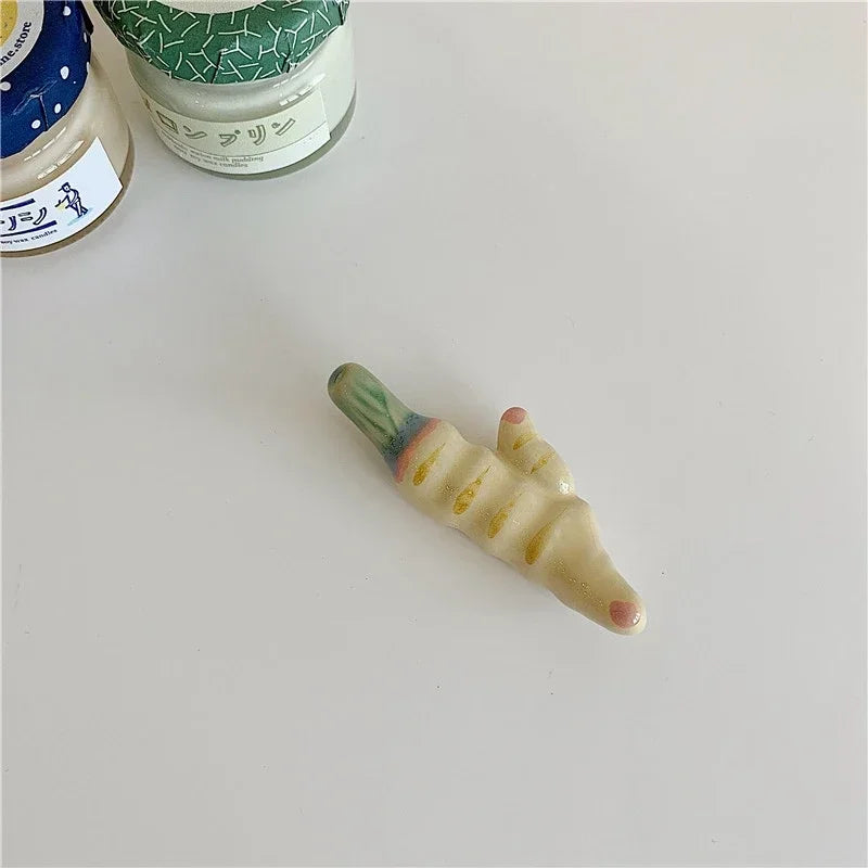 A vegetable shaped ceramic kawaii chopstick holder on a table