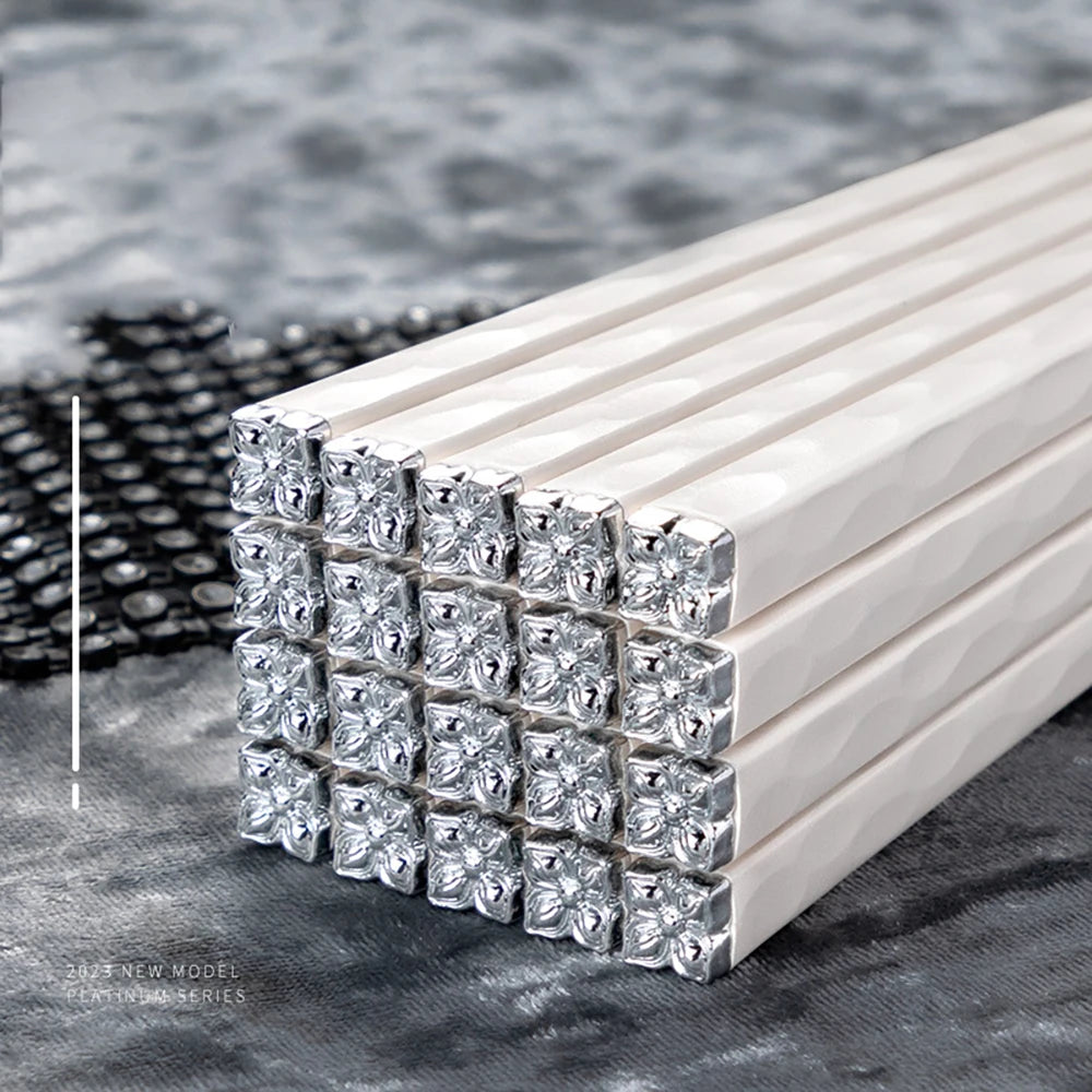 Stack of kawaii chopsticks with diamond-shaped ends on a textured surface