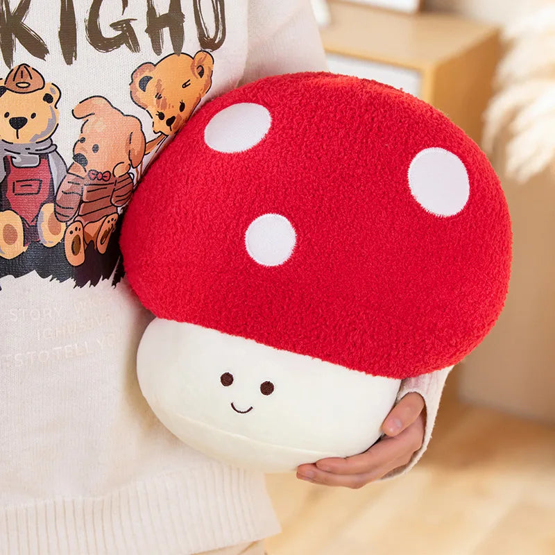 Red mushroom-shaped kawaii pillow held by a person with a book featuring teddy bears in the background.