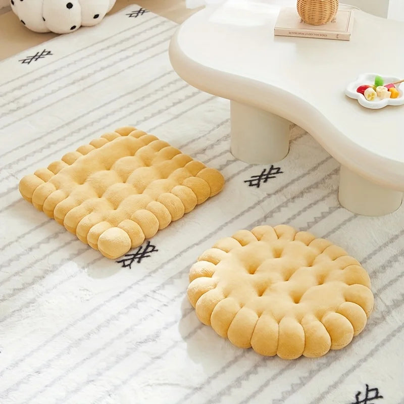 Two round, textured yellow kawaii cushions on a white floor with a light-colored table in the background.