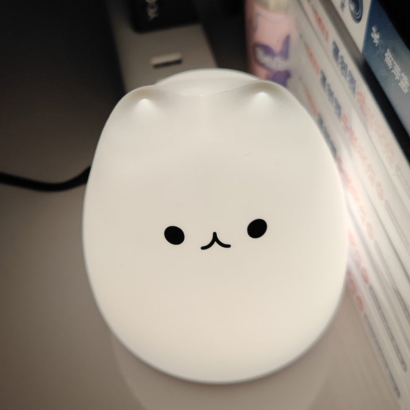 White kawaii mouse with a simple face design on a desk
