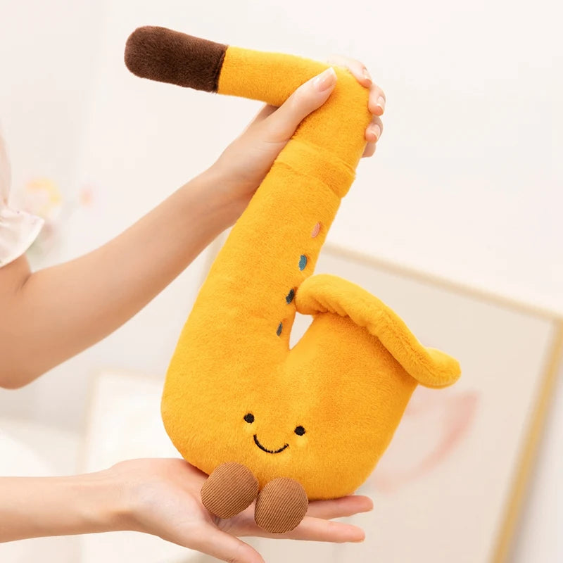 Kawaii plush banana toy held in hands against a neutral background