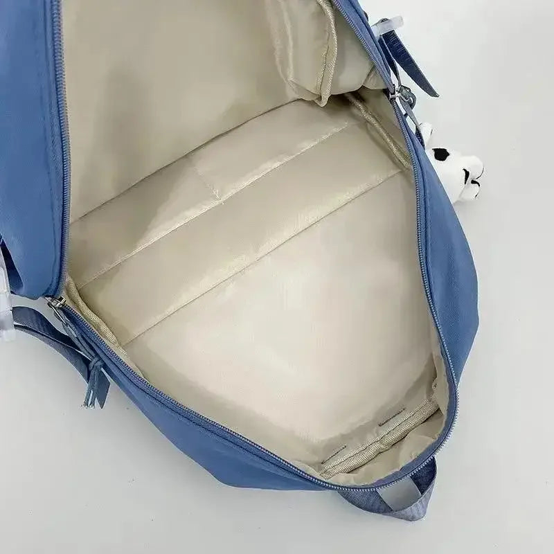 Kawaii-inspired blue backpack with beige interior on a white background