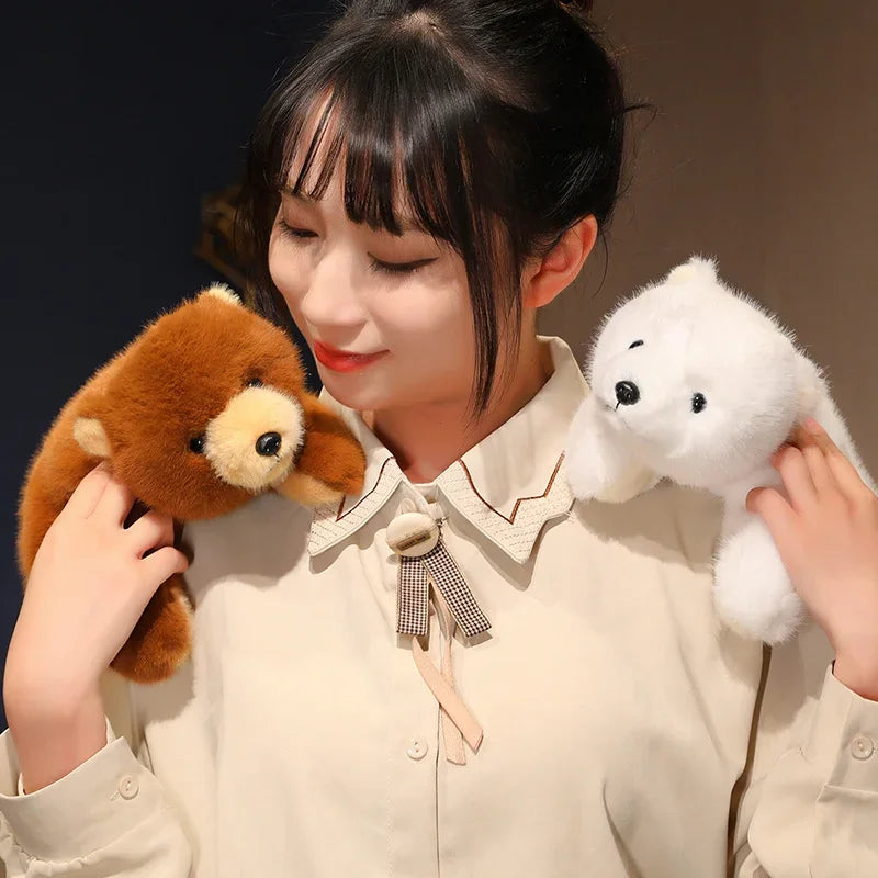 Person holding two kawaii plush toys, one brown and one white, against a dark background