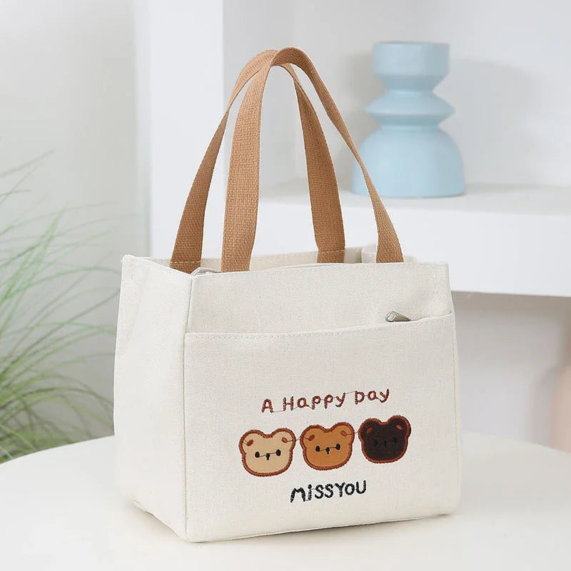 White kawaii tote bag with brown handles and bear illustrations on a white surface.