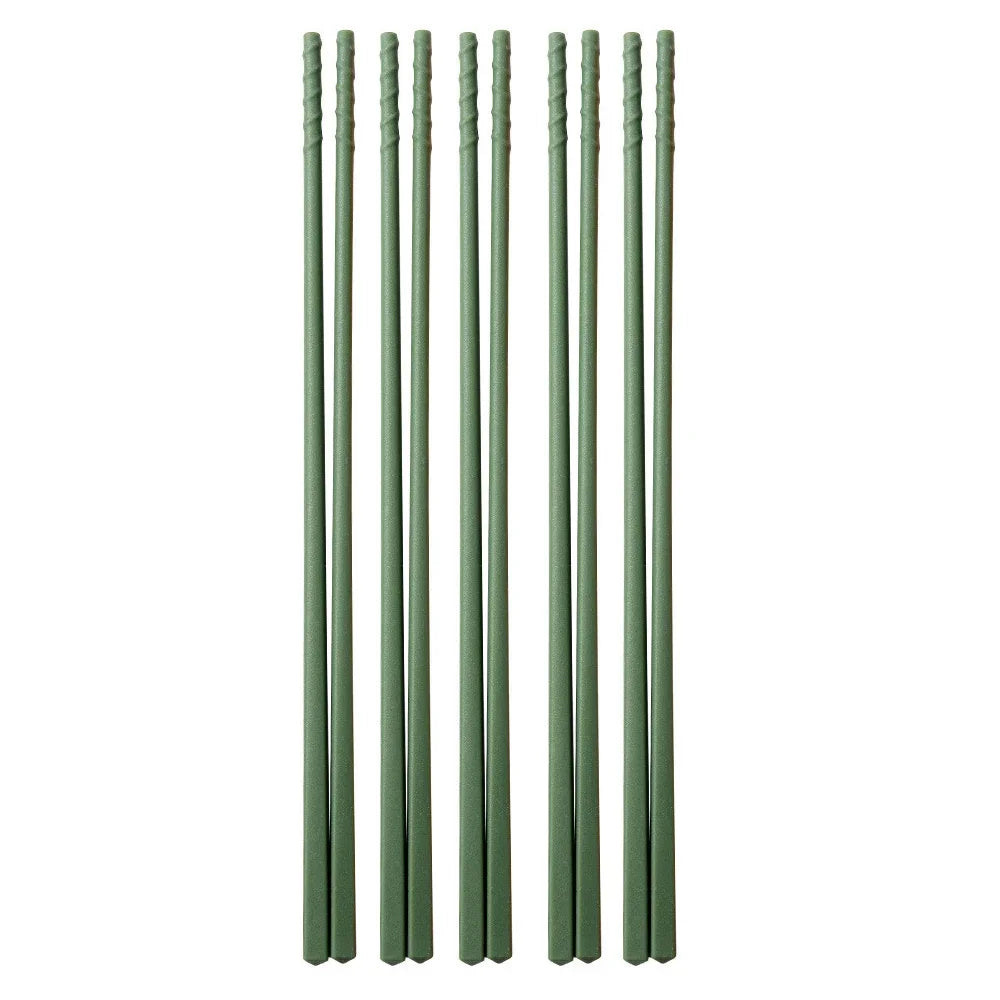 Set of six green kawaii chopsticks on a white background