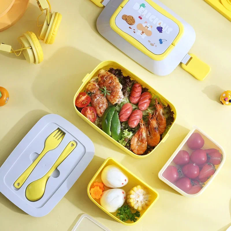 Yellow kawaii bento box with compartments containing food on a yellow background