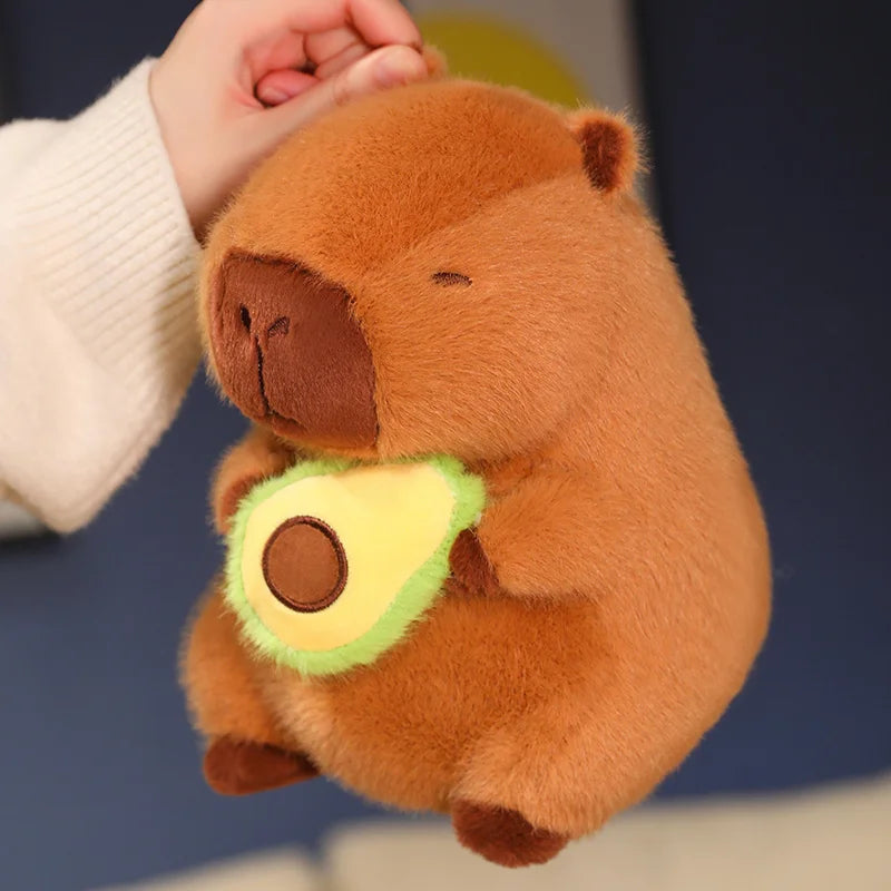 Kawaii plush toy beaver holding an avocado with a blurred background