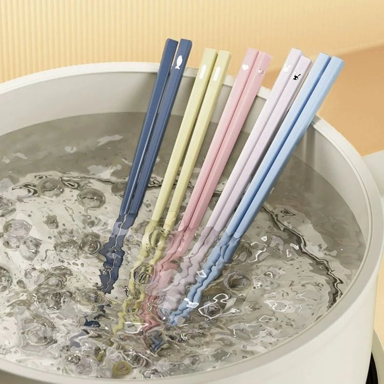 Set of colorful kawaii chopsticks in a sink with water