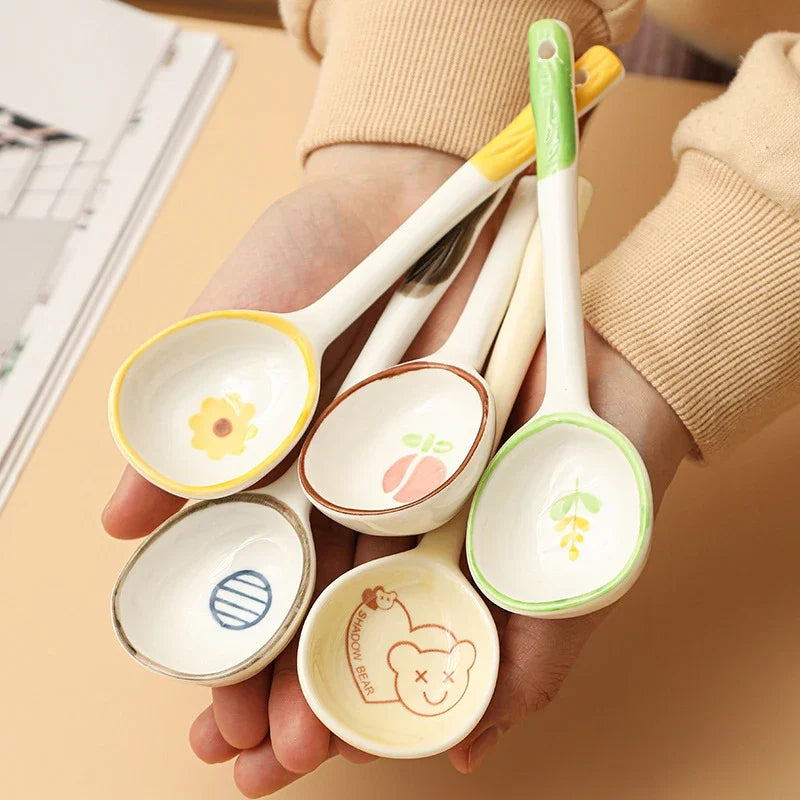 A person holding a group of kawaii spoons