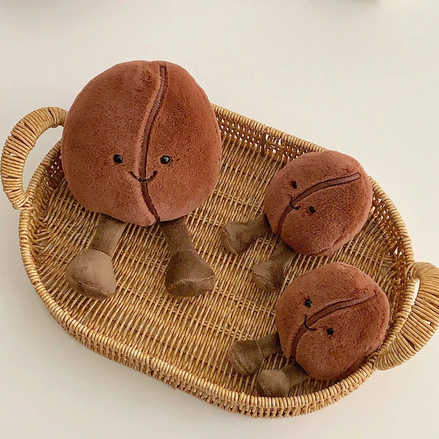 Three brown kawaii plush toys resembling tortoises on a wicker tray.