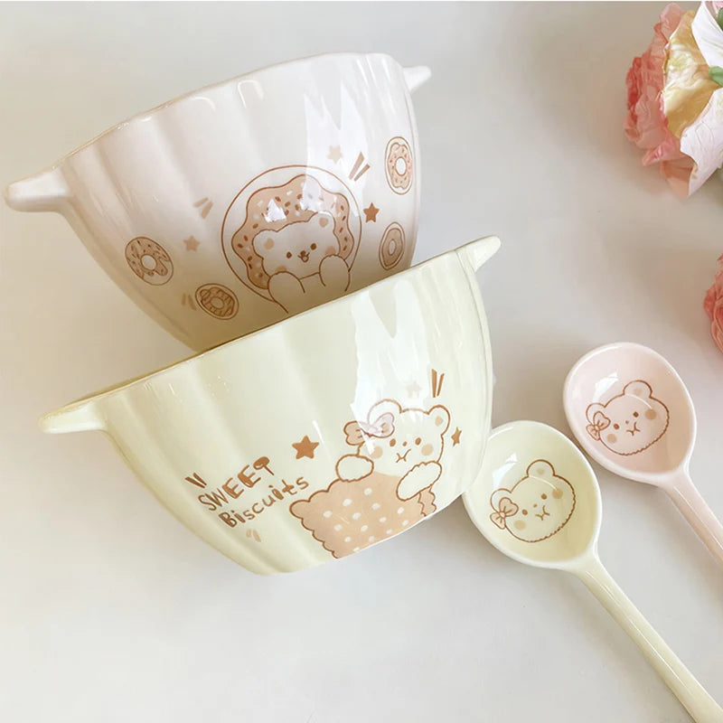 Two pumpkin shaped kawaii bowls next to two spoons