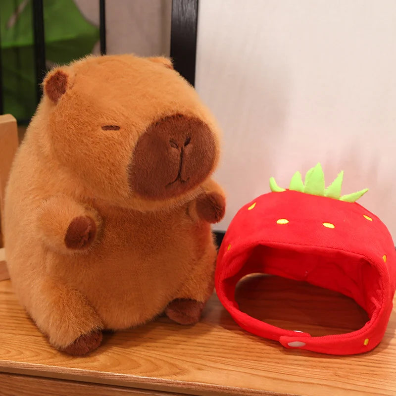 Kawaii plush toy bear and strawberry-shaped pet bed on a wooden surface