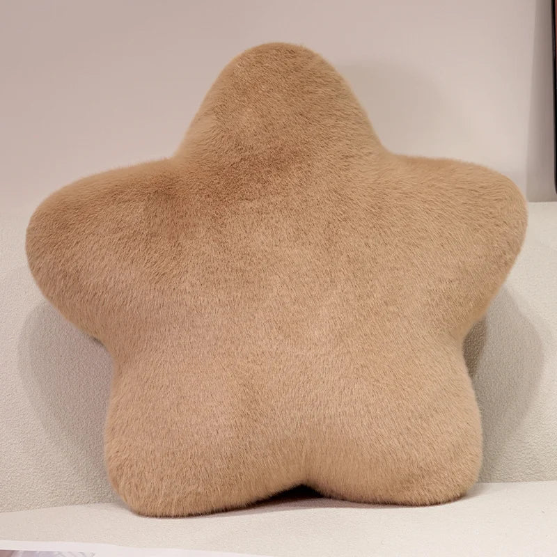 Star-shaped beige pillow on a light-colored couch