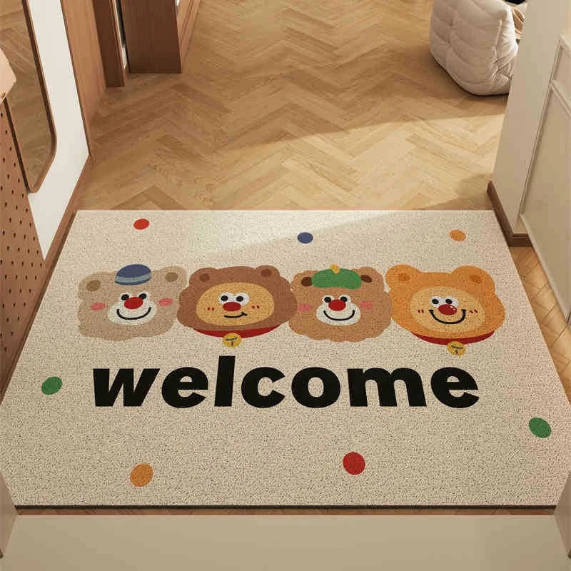 Doormat with Kawaii cartoon bear faces and 'welcome' text on a wooden floor.