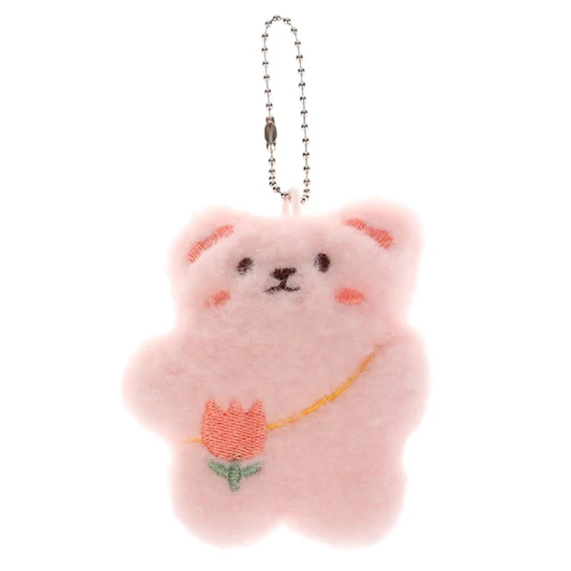 Pink kawaii bear plush keychain with a tulip on a white background