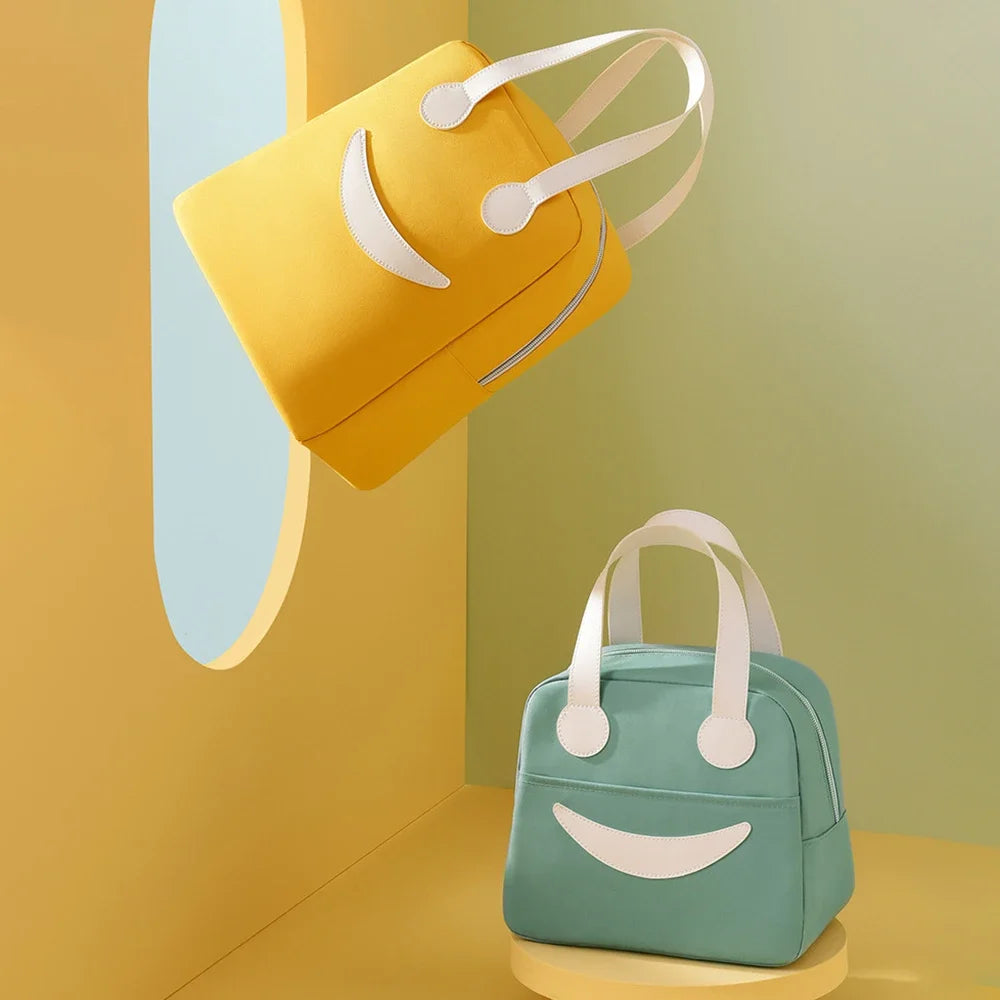 Two kawaii lunch bags, one yellow and one green, with white handles on a colorful background.