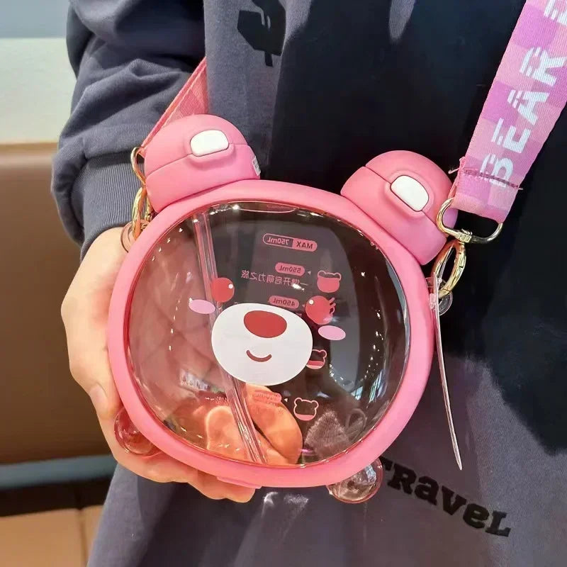 Pink transparent kawaii water bottle with cartoon character design held by a person