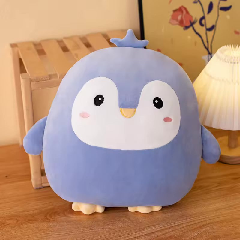 Cute kawaii plush toy penguin on a wooden floor with a lamp and plant in the background