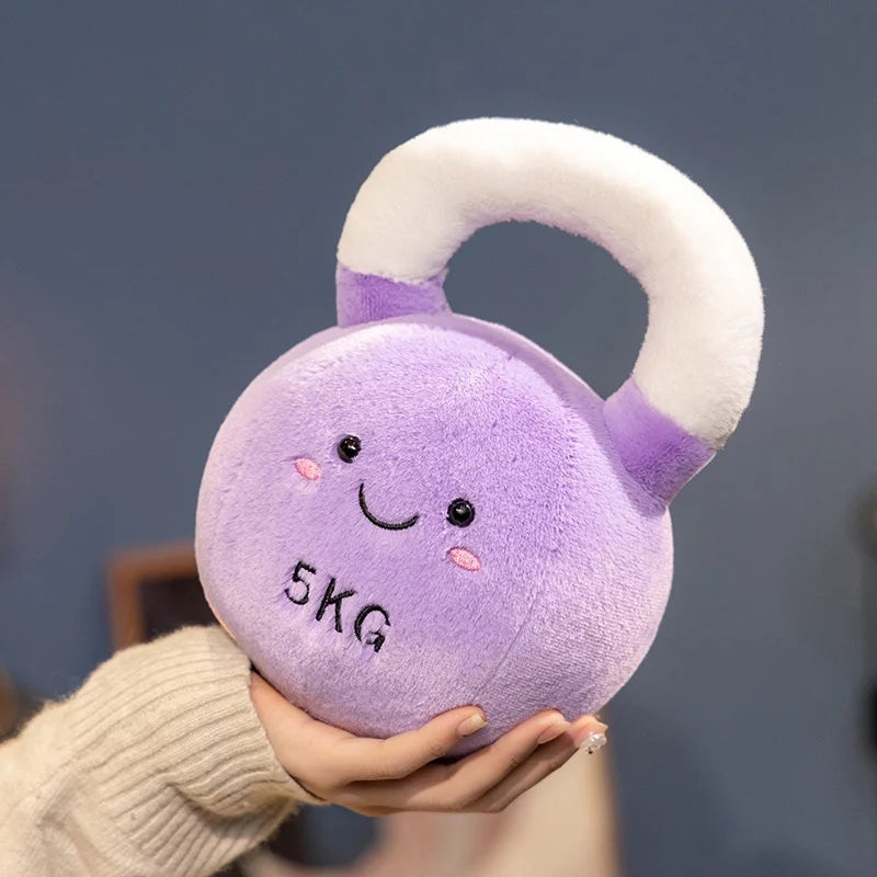Kawaii plush purple kettlebell with a smiling face held by a person against a blurred background