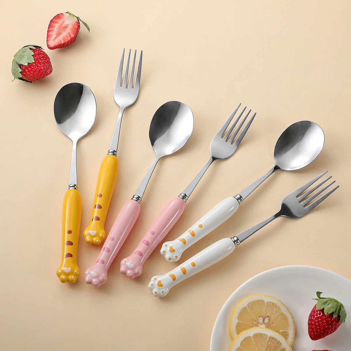Set of colorful kawaii utensils with animal print handles on a beige background
