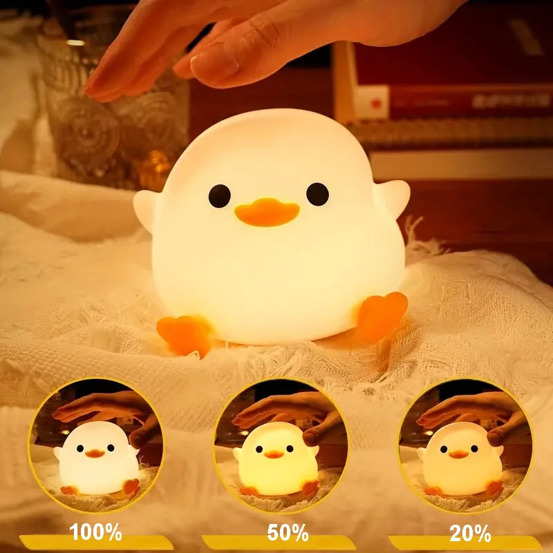 Cute chick-shaped kawaii night light with a hand interacting with it, set against a soft focus background.
