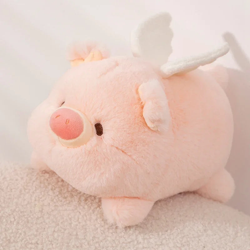 Kawaii plush toy pig with antlers on a soft surface