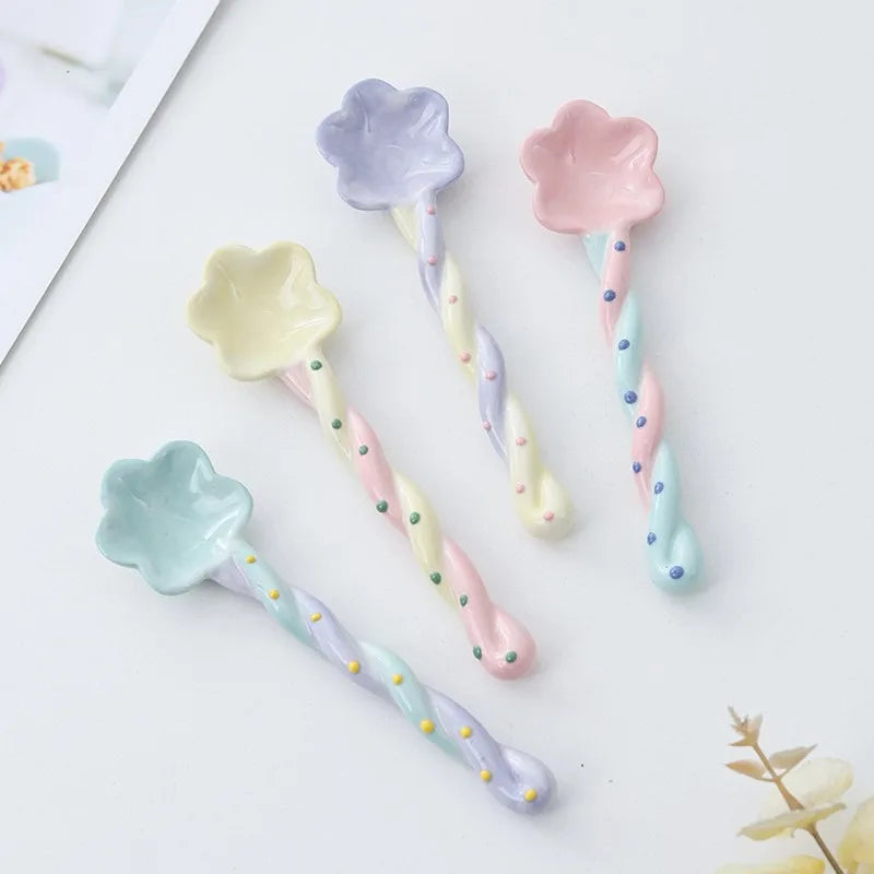 Four rainbow ceramic kawaii spoons on a table