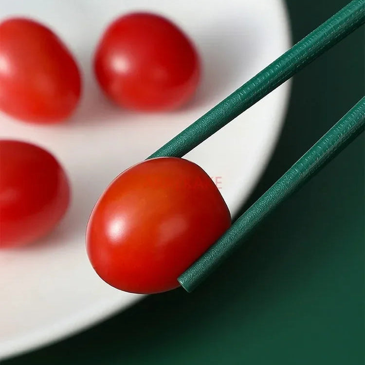 Cherry tomatoes on a white plate with green kawaii chopsticks
