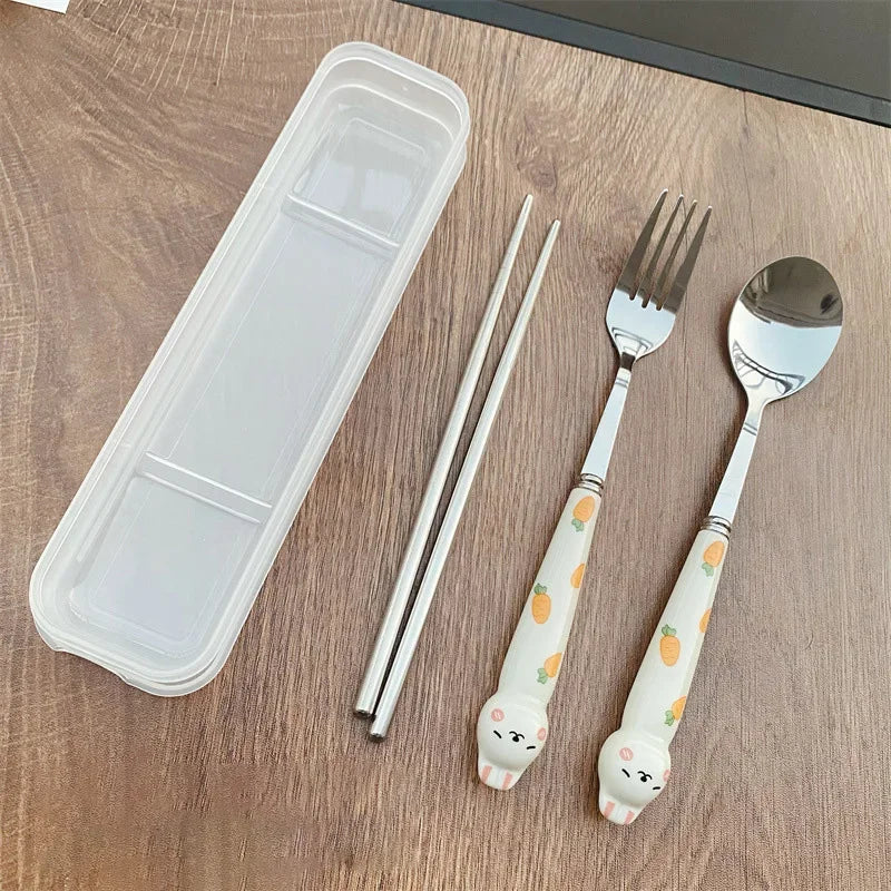Children's kawaii utensils set with fork, spoon, and chopsticks on a wooden surface