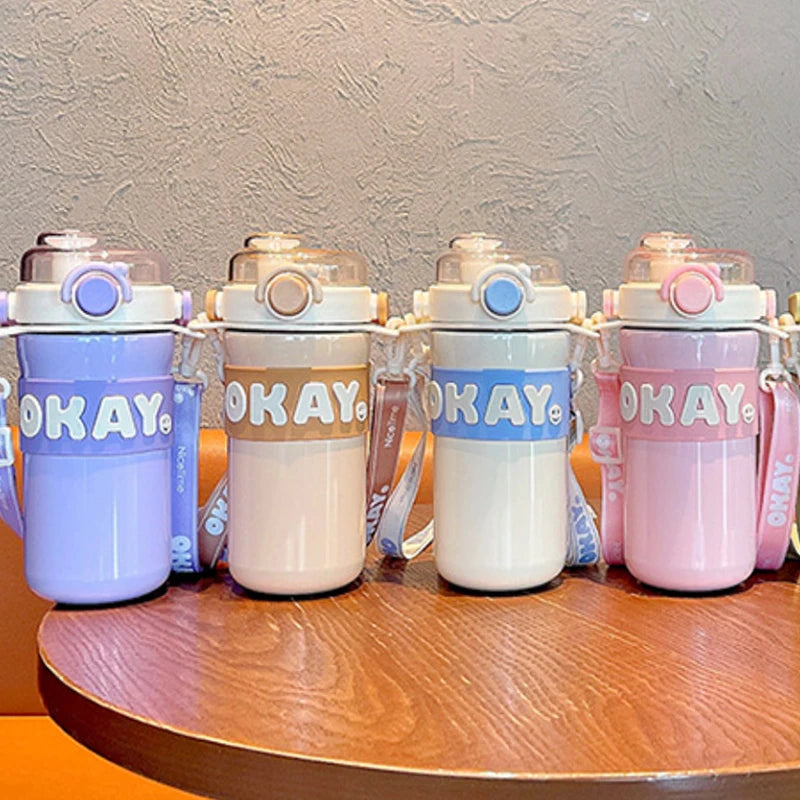 Set of colorful kawaii water bottles on a wooden surface with a neutral background