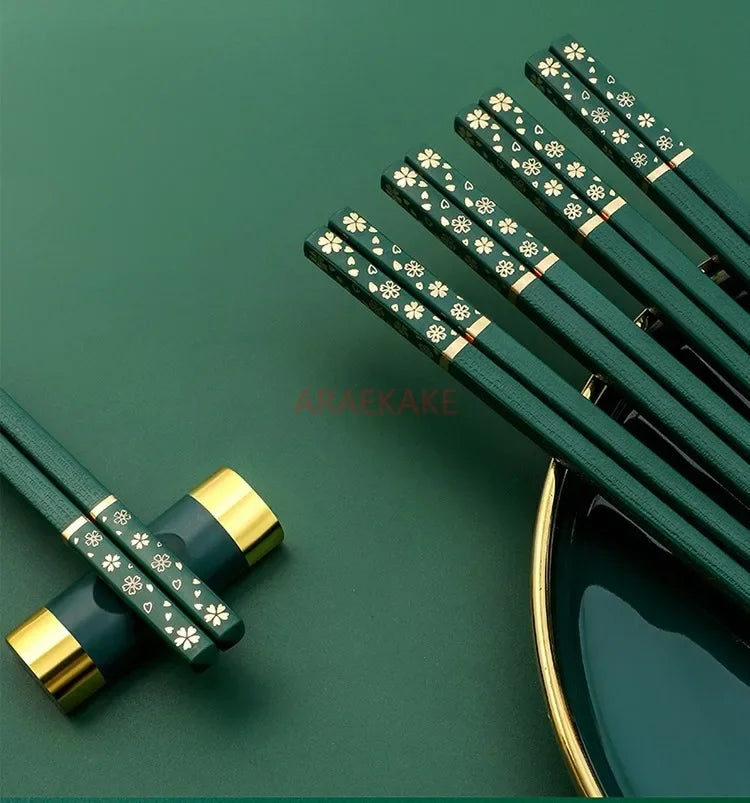 Green kawaii chopsticks with gold accents on a green background