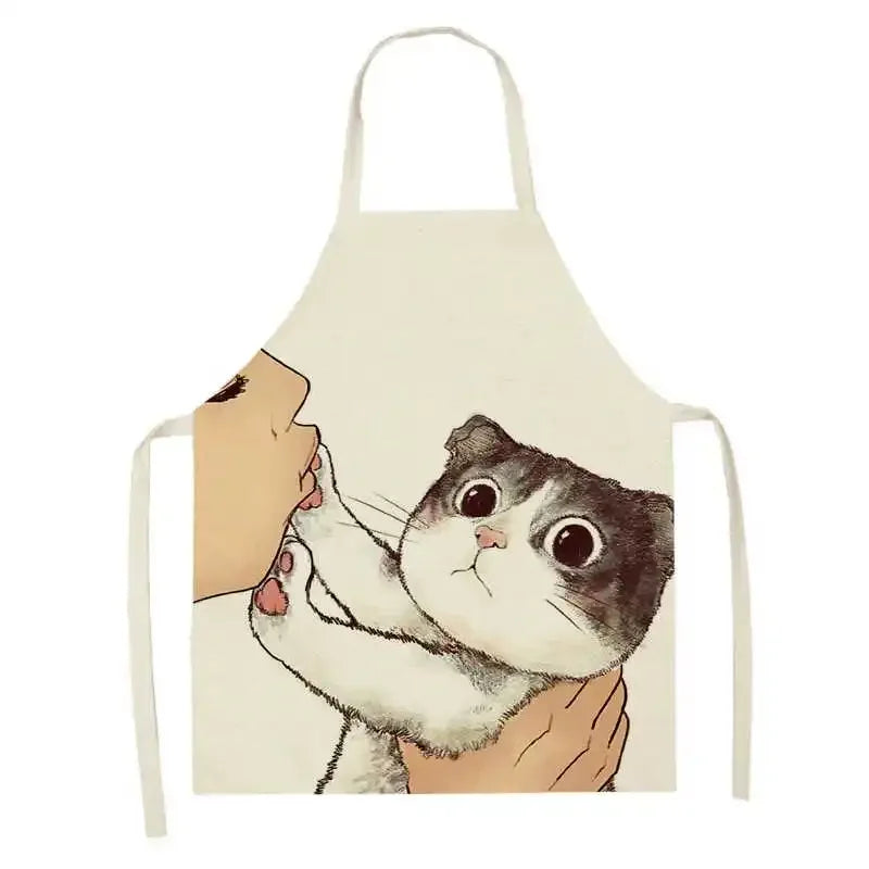 Kawaii apron with a design of a cat being held by a person's hands on a white background
