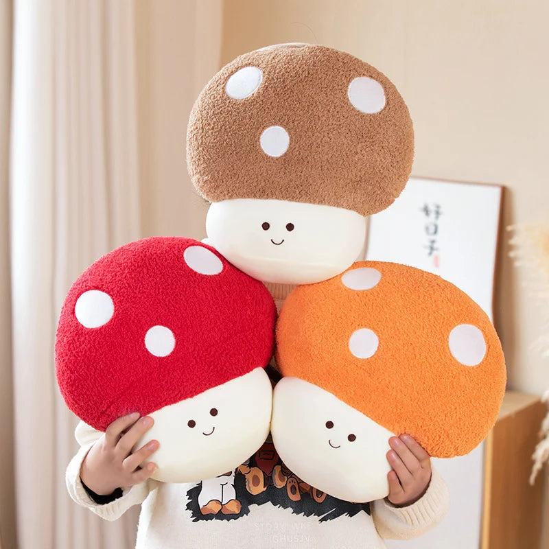 Three kawaii plush mushroom toys held by a person wearing a matching outfit.