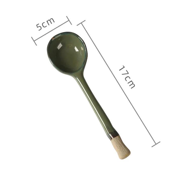 A green ceramic kawaii spoon with measurements