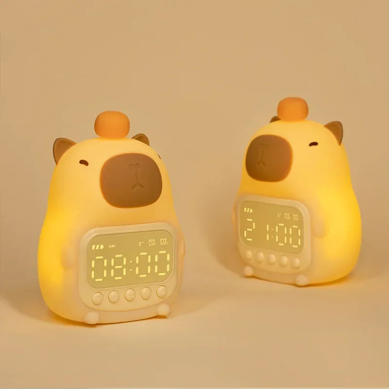 Two yellow animal-shaped kawaii alarm clocks on a beige background