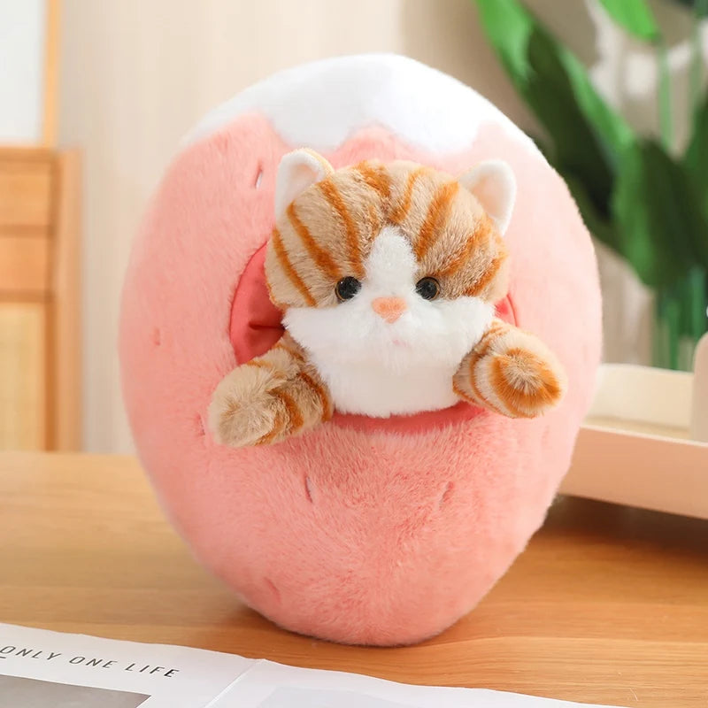 Kawaii plush toy cat sitting inside a pink ball on a wooden surface.